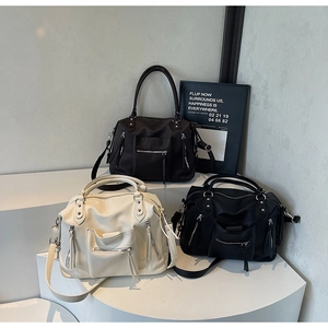Detail view of large American retro tote bags in black, beige, and coffee textured leather