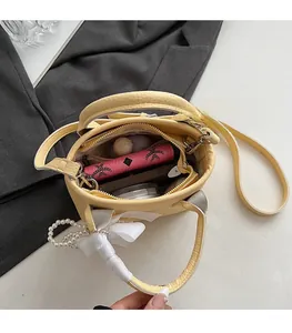 Top-down view of yellow bucket bag interior showing spacious storage for wallet and phone