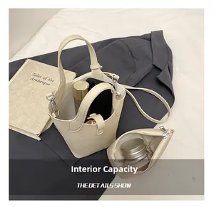 Top view of cream bucket bag set showing inner capacity with leather pouch and strap