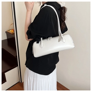 Side view of white leather underarm bag with double zipper and slim shoulder strap