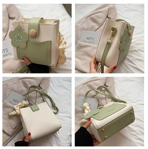 Detail view of contrast square bag with wooden button and flower charm from all angles