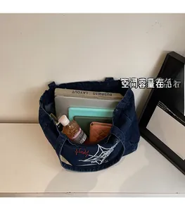 Detail of Gothic denim tote bag showing large capacity with laptop and daily essentials