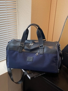 Large capacity navy blue fabric travel bag with leather trim and detachable shoulder strap