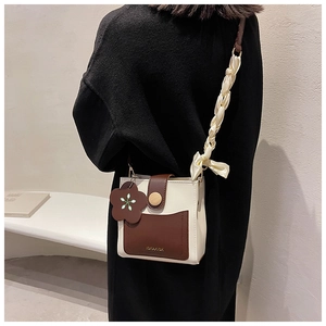Detailed back view of a contrast color crossbody square bag with decorative silk scarf handle