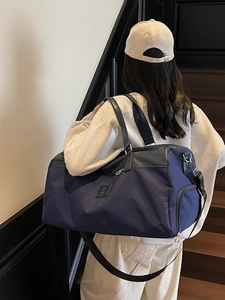Navy blue large capacity nylon travel bag with shoulder straps for women commuters