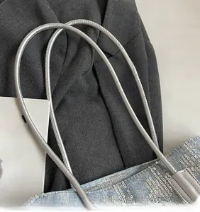 Detail of light blue denim tote with silver sequins and metallic long shoulder strap
