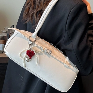 White faux leather shoulder bag for women with pearl strap and red heart charm pendant