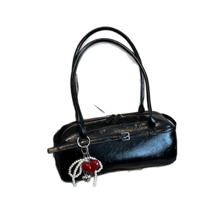 Glossy black barrel handbag for women with red heart charm and pearl strap detail