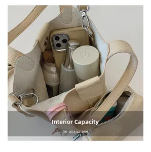 Macro view of interior storage capacity in beige litchi leather bucket bag