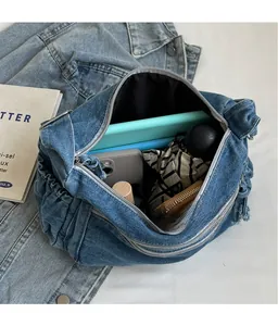 Spacious interior of denim tote bag showing tablet, phone, umbrella, and daily items