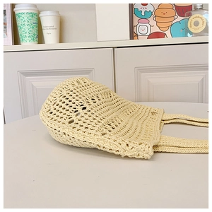 Detail of cream beige crochet tote bag showing hollow knit texture and soft cotton fabric