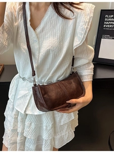 Dark brown vintage crossbody bag with pleated leather texture and silver hardware