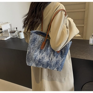 Detailed view of blue and silver sequin tote bag with brown leather straps for commuting