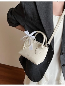 Elegant cream-white crossbody bucket bag with pearl bow and silk ribbon detail