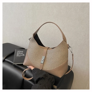 Detailed macro of the woven straw texture and premium brown leather side on the hobo bag