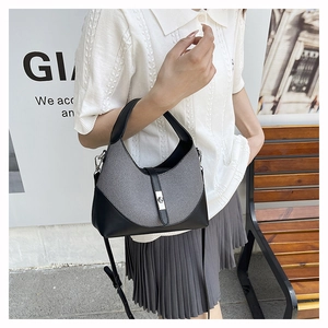 Detail showing the gray woven fabric texture and black leather trim of the hobo handbag