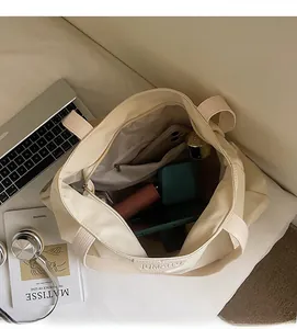 Interior view of large capacity canvas tote bag with zipper pocket and daily essentials