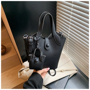 Close-up of black lychee grain leather bucket bag with silver metal hardware and mini pouch