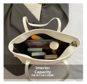 Detailed interior of a white tote bag showing spacious storage for iPad and daily essentials