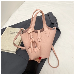 Close-up of pink lychee pattern PU leather bucket bag with silver hardware and mini pouch