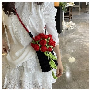Close-up of handmade crochet bucket bag featuring 3D red roses and green leaves details