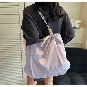 Detailed view of the large lilac nylon tote bag showing its lightweight texture and strap