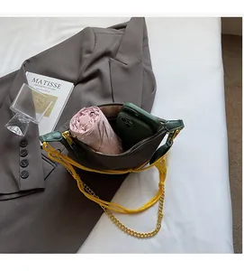 Top view of nylon crossbody bag interior showing storage for an umbrella and smartphone