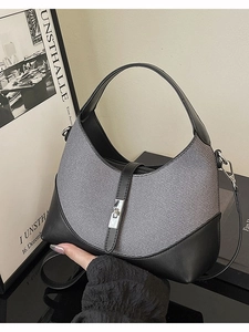 Gray canvas and black leather crossbody bag with silver metallic twist lock closure