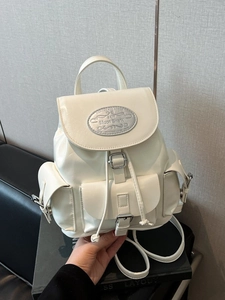 Minimalist cream faux leather backpack with bucket drawstring and multiple pockets
