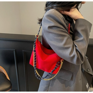 Detail of red nylon hobo bag with dual gold chain and woven rope shoulder straps