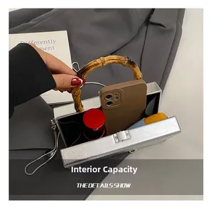 Internal capacity of silver small square bag showing space for phone and makeup