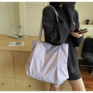 Detail view of the light purple nylon tote bag with brand logo and wrinkled texture fabric