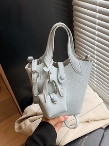 Light blue lychee texture leather bucket bag with a mini pouch charm and shoulder strap