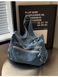 Vintage blue denim tote bag with functional zipper layers and adjustable side drawstrings