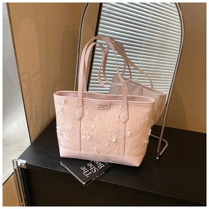 Close-up of pink tote bag featuring 3D mesh flower decor and premium texture