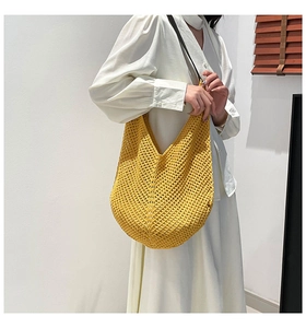 Detail of yellow hollow knit shoulder bag showing handcrafted crochet texture and pattern