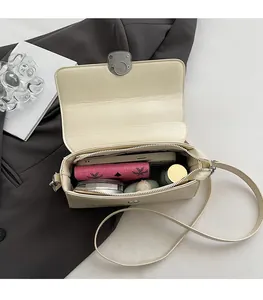 Detailed view of the spacious interior of a beige square bag showing daily item storage