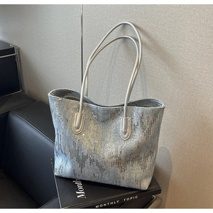 Detail of silver blue sequin embroidery and long leather straps on large tote bag