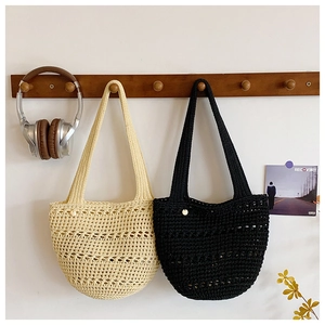 Detailed macro view of hollow knitted crochet tote bag with textured weaving patterns