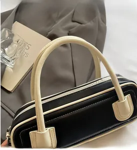 Close-up of contrast black and white rectangular leather handbag with dual handles