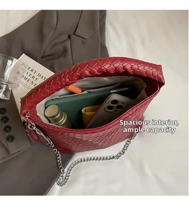Spacious interior of dark red woven bucket bag showing capacity for phone and cosmetics