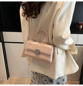 Minimalist beige crossbody bag on model back view in a minimalist interior setting