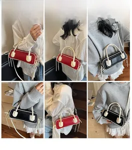 Multiple views of a two-tone baguette shoulder bag worn as a crossbody or underarm bag
