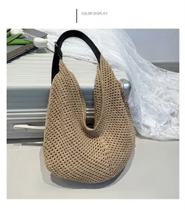 Detail of khaki woven hobo bag with knit texture and black leather shoulder strap