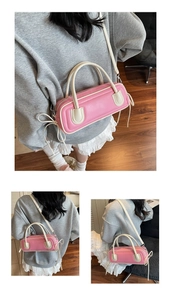 Detail of pink cylindrical baguette bag with side ribbon bow and detachable shoulder strap