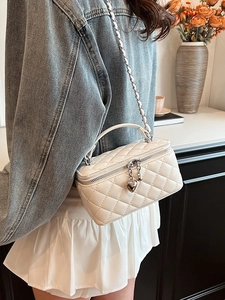 Chic quilted white vanity crossbody bag with gold heart charm and woven chain strap