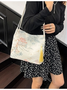 Crossbody bucket bag with Chinese style landscape embroidery and yellow tassel pendant