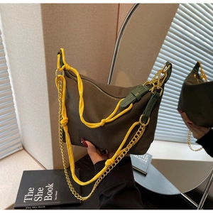 Detailed shot of coffee canvas hobo bag with yellow rope and gold chain strap
