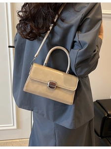 Fashionable beige faux leather square handbag with silver metal buckle and top handle