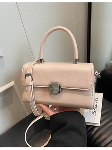 Elegant light pink PU leather crossbody handbag with silver buckle and round top handle